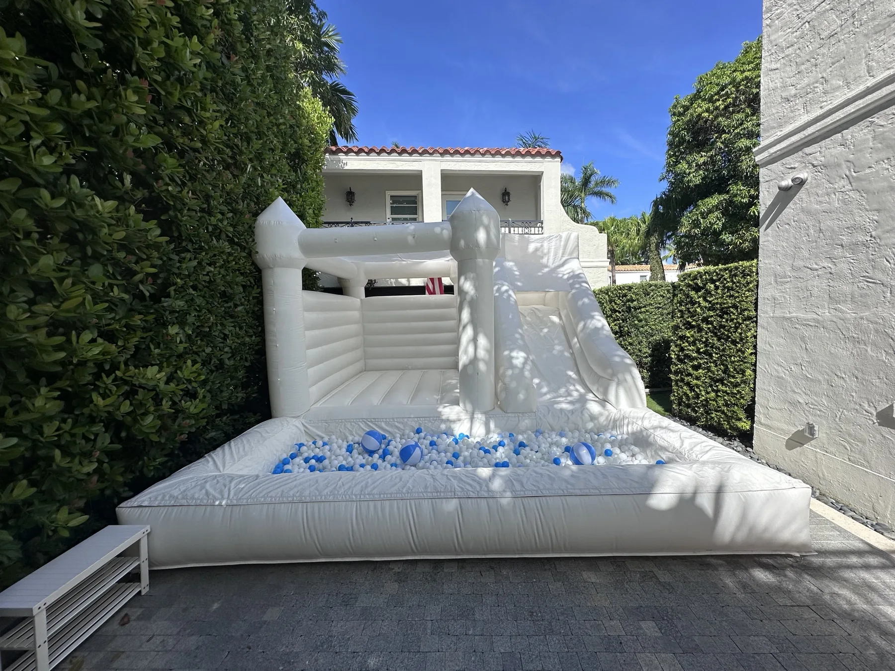 3-in-1 Empire Castle bounce house rental set up for a kids party in Miami, 16 × 16 ft white — 1 of 6