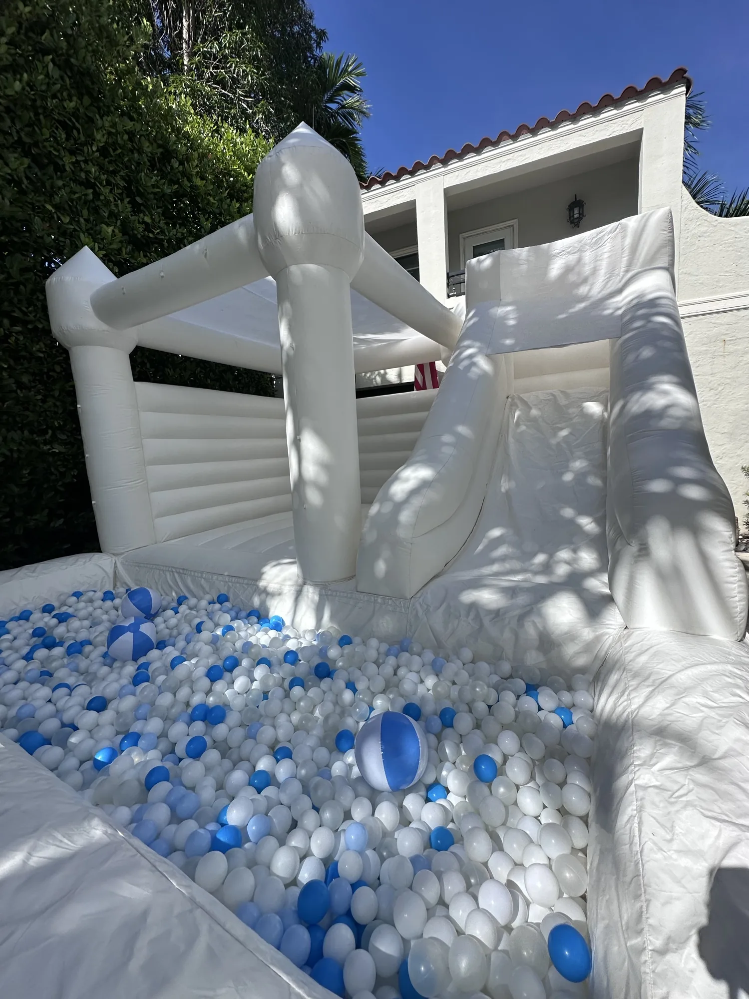 3-in-1 Empire Castle bounce house rental set up for a kids party in Miami, 16 × 16 ft white — 2 of 6