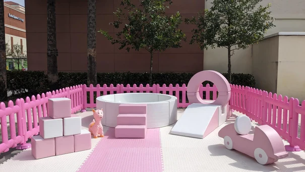 Pink soft play station with ball pit and slide at a Miami birthday party