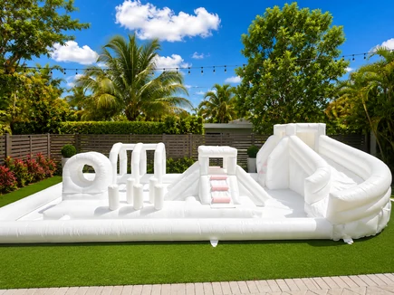 Splash Station water inflatable rental set up for a kids party in Miami, 15 × 30 ft white
